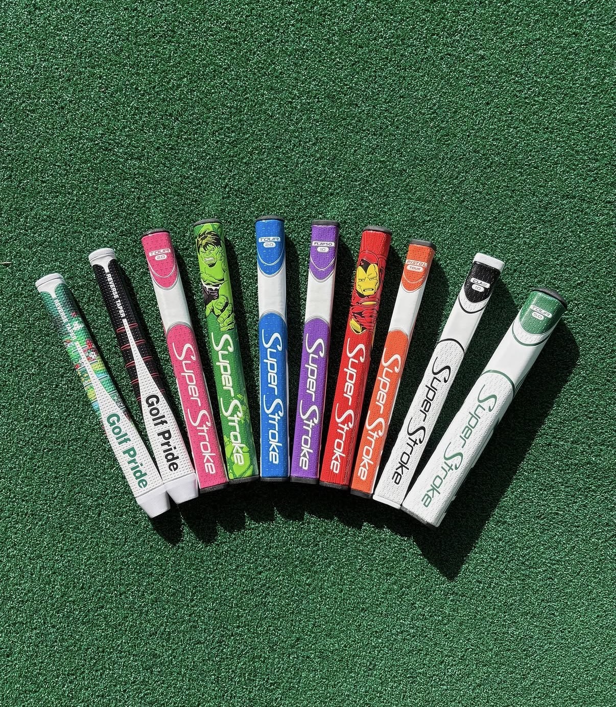 Golf Pride and SuperStroke putter grip examples on green turf